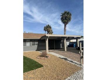 Single-story home with carport and landscaped front yard at 3937 Jackpot Cir, Las Vegas, NV 89107