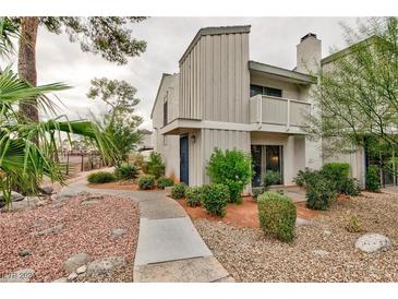 Two-story home with a balcony, desert landscaping, and a walkway at 510 Delfern Ln, Las Vegas, NV 89169