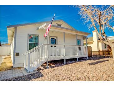 Charming single-story home with a covered front porch and white siding at 664 California Ave, Boulder City, NV 89005