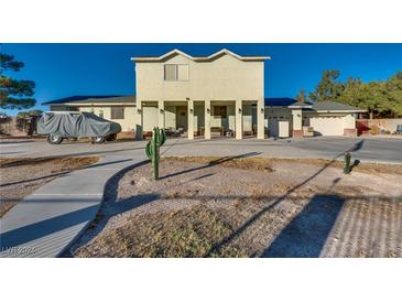 Two-story house with a large driveway and landscaped yard at 7320 Bath Dr, Las Vegas, NV 89131