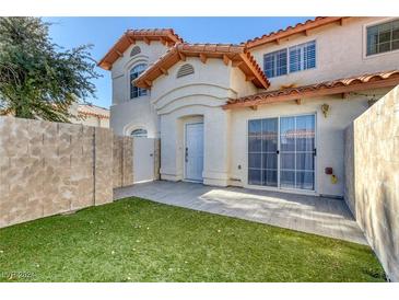 Private backyard with a patio and lush green lawn at 3428 Twilight Star Dr, Las Vegas, NV 89117