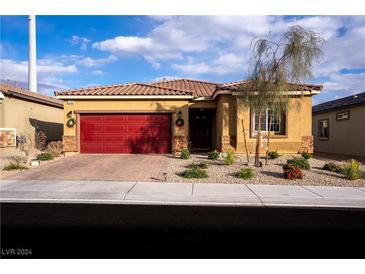 Charming single-story home with a red garage door and landscaped front yard at 7198 Liberty Landing St, Las Vegas, NV 89166