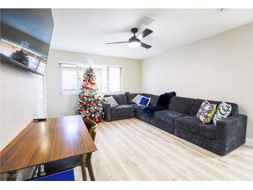 Inviting living room with cozy sectional sofa, festive Christmas tree, and wood-look flooring at 244 N Bruce St # D, Las Vegas, NV 89101