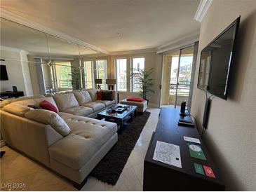 Spacious living room with large sectional sofa and flat-screen TV at 230 E Flamingo Rd # 223, Las Vegas, NV 89169