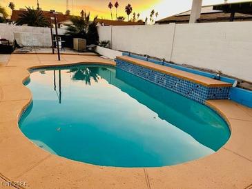 Inviting pool with a raised tile border and sunset view at 2759 Long Ct, Las Vegas, NV 89121