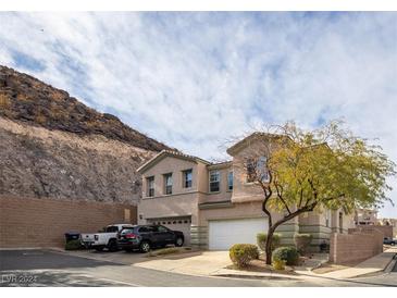 Two-story house with attached garage and desert landscape in the background at 223 Guidance Ridge Ct, Henderson, NV 89012