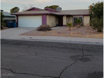 Single-story house with attached garage and landscaping at 4012 Mira Ln, Las Vegas, NV 89108