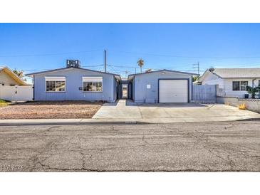 Ranch style home with attached garage and landscaped yard at 5435 Cortina Ave, Las Vegas, NV 89142