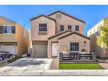 Two-story house with attached garage and landscaped front yard at 5299 Emelita St, Las Vegas, NV 89122