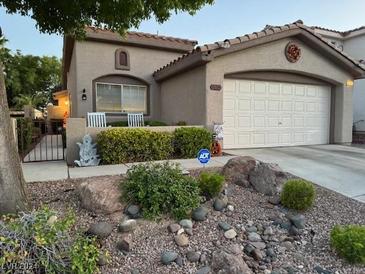 Single-story house with a two-car garage and desert landscaping at 7705 Sublimity Ave, Las Vegas, NV 89131