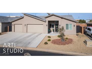 Single-story home with attached two-car garage and landscaped front yard at 841 Santa Theresa Way, Mesquite, NV 89027