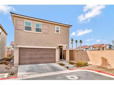 Two-story house with brown garage door and small front yard at 1975 Via Primero St, Las Vegas, NV 89115