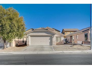 Single-story house with a white garage door and landscaping at 6754 Broadacres Ranch St, Las Vegas, NV 89148