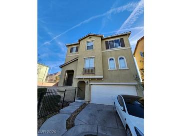 Three-story house with attached garage and small front yard at 7071 Canary Ivy Way, Las Vegas, NV 89156