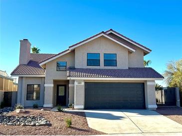 Two-story house with dark brown garage door and landscaped front yard at , Las Vegas, NV 89110