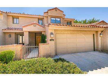 Two-story townhome with attached garage and landscaped front yard at 7327 Mission Hills Dr # 0, Las Vegas, NV 89113