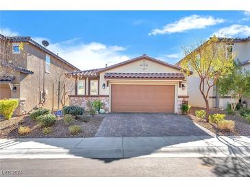 Single-story home with a two-car garage and well-manicured landscaping at 9183 Lynea Ct, Las Vegas, NV 89178