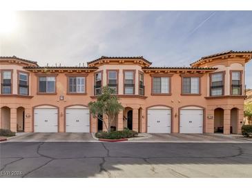 Three-unit townhome building with attached garages and desert landscaping at 30 Via Vasari # 104, Henderson, NV 89011