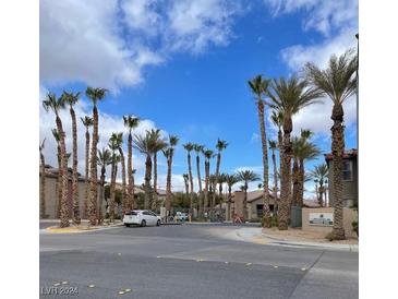 Gated community entrance with palm trees and well-maintained landscaping at 8000 W Badura Ave # 2092, Las Vegas, NV 89113