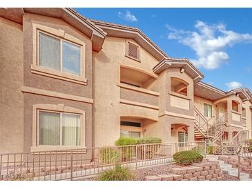 Tan two-story building with several units, stairs, and landscaping at 8805 Jeffreys St # 1029, Las Vegas, NV 89123