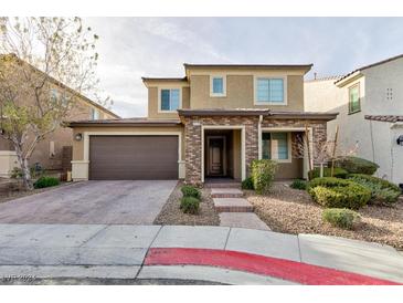 Two-story house with brown garage door and brick accents at 2179 Tortona St, Henderson, NV 89044