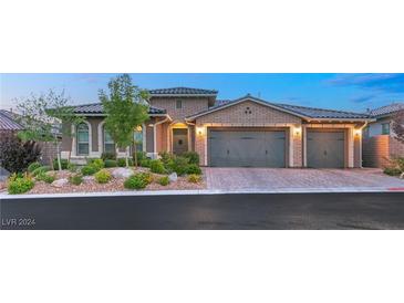 Beautiful two-story home with a three-car garage and landscaped front yard at 12135 Castilla Rain Ave, Las Vegas, NV 89138