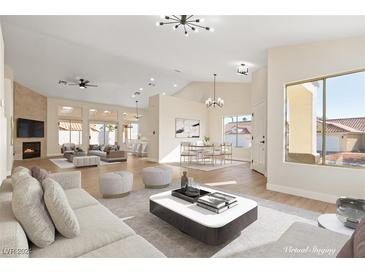 Bright living room with hardwood floors, fireplace, and open floor plan at 4596 Brently Pl, Las Vegas, NV 89122