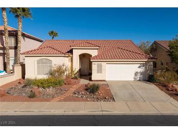 Single-story house with tile roof, white garage door, and landscaped front yard at 730 Descartes Ave, Henderson, NV 89002