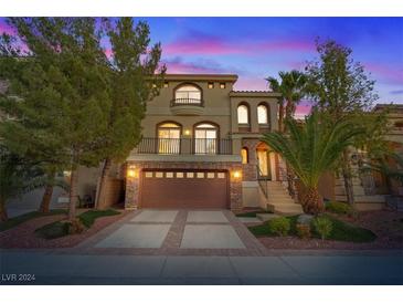 Beautiful two-story home with a three-car garage and mature landscaping at 9842 Belle Marie Ct, Las Vegas, NV 89141