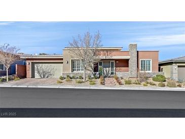 Single-story home with attractive landscaping and two-car garage at 10150 Emerald Sunset Ct, Las Vegas, NV 89148