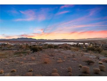 Stunning aerial view of lakefront property with mountain backdrop at 20 Via Visione # 104, Henderson, NV 89011