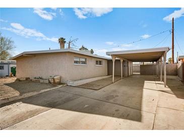 Ranch style home with carport and landscaped front yard at 4521 Harmon Cir, Las Vegas, NV 89122