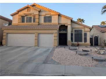 Two-story house with a two-car garage and landscaped front yard at 1580 Bozeman Dr, Henderson, NV 89012