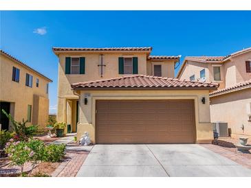 Two-story house with tan exterior, brown garage door, and landscaping at 2795 Murray Hill Ln, Las Vegas, NV 89142