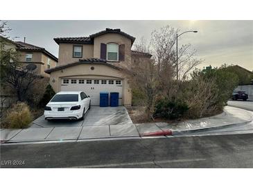 Two-story house with attached garage and landscaped front yard at 9505 W Gilmore Ave, Las Vegas, NV 89129