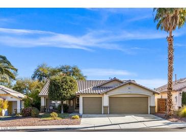 Single-story house with three-car garage and desert landscaping at 310 Coral Fountain St, Henderson, NV 89014