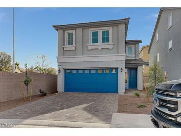 Two-story house with blue garage door and paved driveway at 6007 Whitmire Ave, Las Vegas, NV 89139