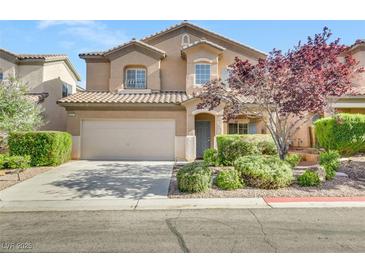 Two-story house with attached garage and landscaped front yard at 6031 Lamotte Ave, Las Vegas, NV 89141