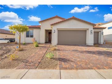 Single-story home with two-car garage and landscaped front yard at 647 Quarry Pass, Mesquite, NV 89034