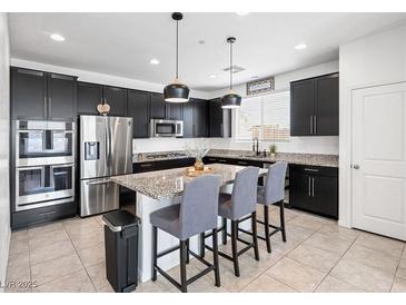 Modern kitchen features stainless steel appliances and granite countertops at 800 Cadence View Way, Henderson, NV 89011