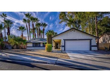 Single-story home with a two-car garage and mature landscaping at 1005 Woodbridge Dr, Las Vegas, NV 89108