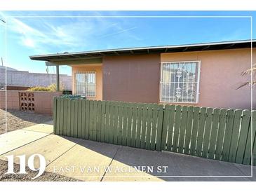 Cute ranch home with a green fence and desert landscaping at 119 E Van Wagenen St, Henderson, NV 89015