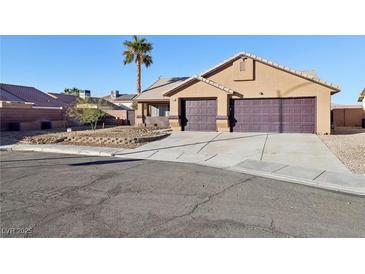 Single-story house with a two-car garage and desert landscaping at 2713 Meadow Spring Ct, Las Vegas, NV 89156