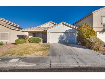 One-story house with a two-car garage and well-manicured lawn at 9978 Coral Cameo Ct, Las Vegas, NV 89183