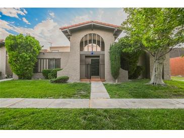 Spanish style home with landscaped lawn and walkway at 4670 Monterey Cir # 1, Las Vegas, NV 89169