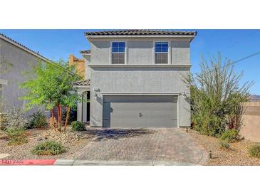 Two-story house with gray siding, gray garage door, and landscaped front yard at 9255 Jade Lagoon St, Las Vegas, NV 89178