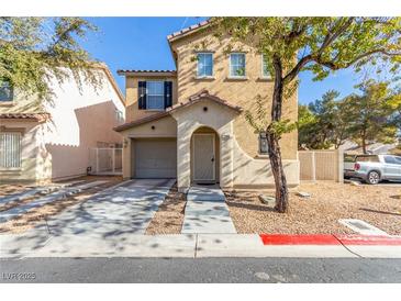 Two-story house with tan siding, attached garage, and a tree in the front yard at 1306 Plum Canyon St, Las Vegas, NV 89142