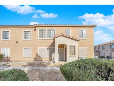 Tan two-story building with a Spanish-style facade, landscaping, and parking at 2019 Rancho Lake Dr # 108, Las Vegas, NV 89108