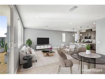 Open concept living room features a neutral color palette and stylish furnishings at 9886 Alpine Style Dr, Las Vegas, NV 89166