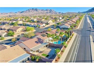 Aerial view of a house with a pool, and desert landscaping in a residential neighborhood at 1017 Amber Gate St, Henderson, NV 89002